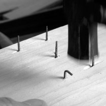 After two strikes the nail's tip is at a 90° angle to where it was originally.