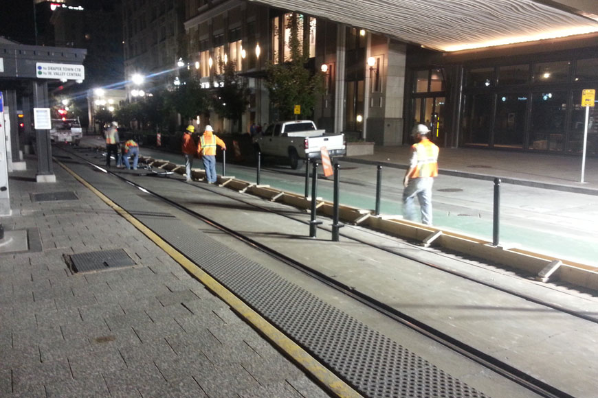 Workers install flexible bollards in Salt Lake City Utah