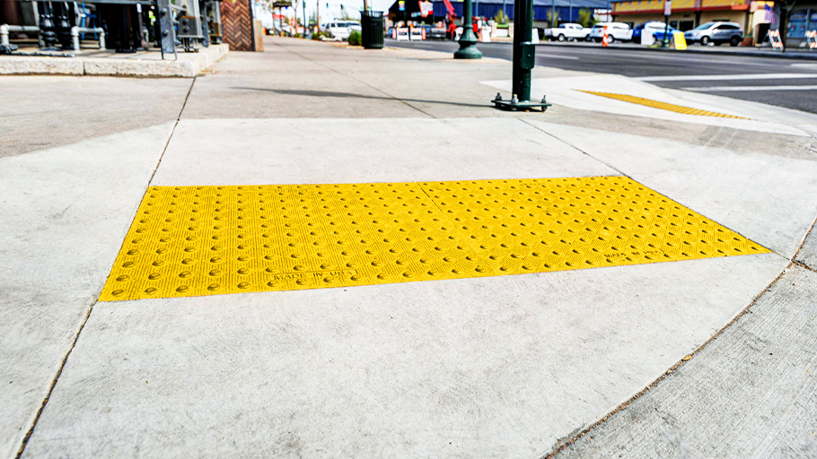 a yellow detectable warning plate