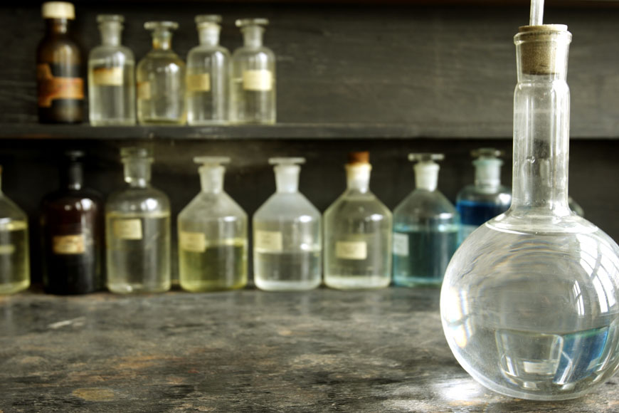 An old laboratory displays beakers filled with colorful liquids 