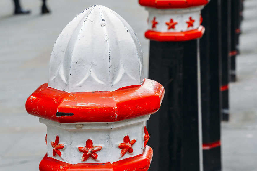 A series of City of London bollards with lemon-juicer shaped caps.