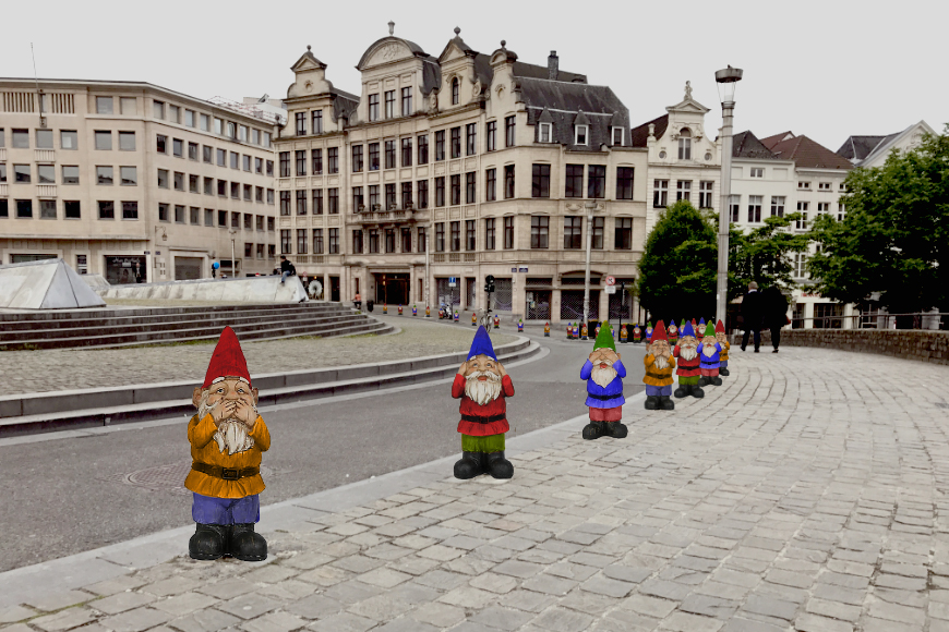 A variety of colorful gnomes stretch along the curb of a traditional European streetscape