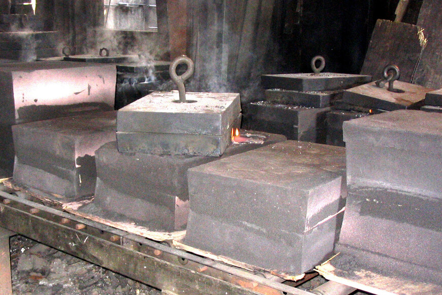 Sand casting molds awaiting shakeout after casting