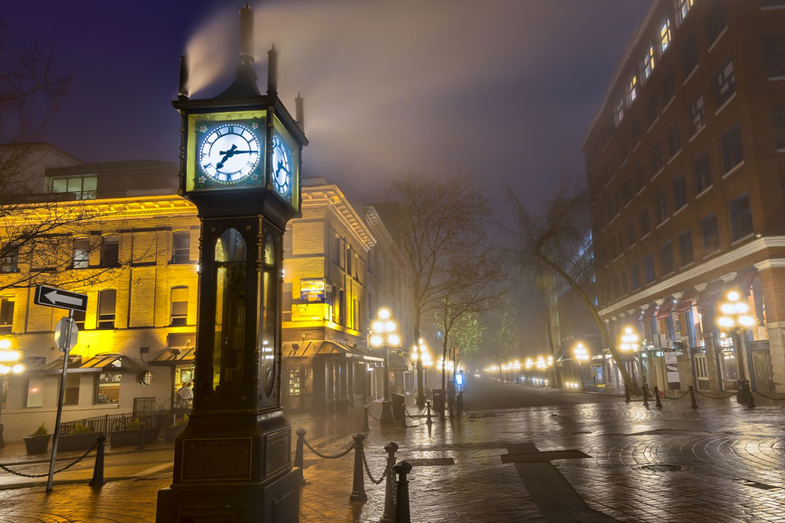 Cast iron bollards surround a steam clock in Gastown