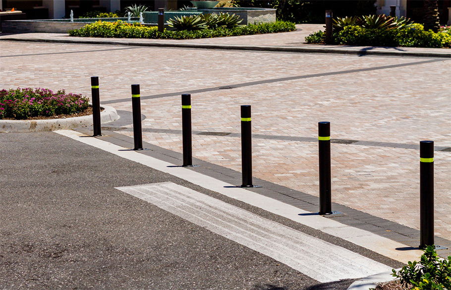 A row of Reliance Foundry bendable bollards installed by an entrance