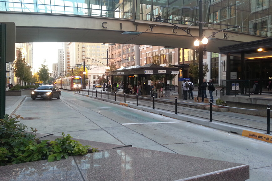 Several closely spaced bollards separate traffic from pedestrians